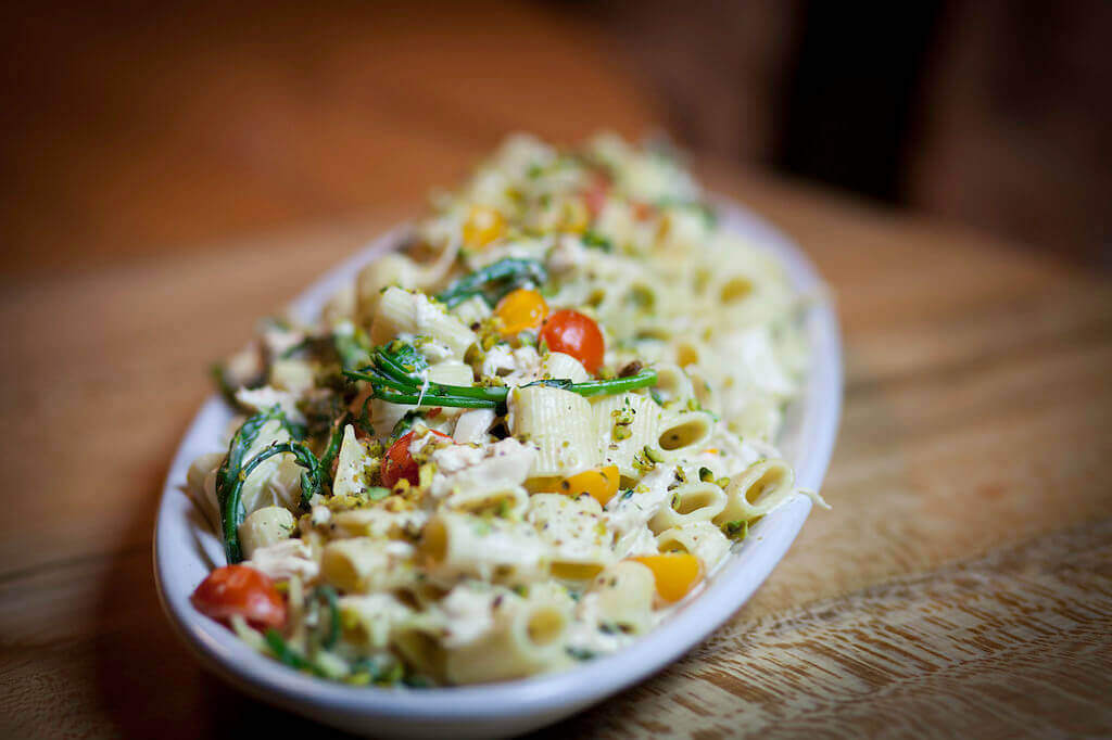 a close up of a plate of food on a wooden table