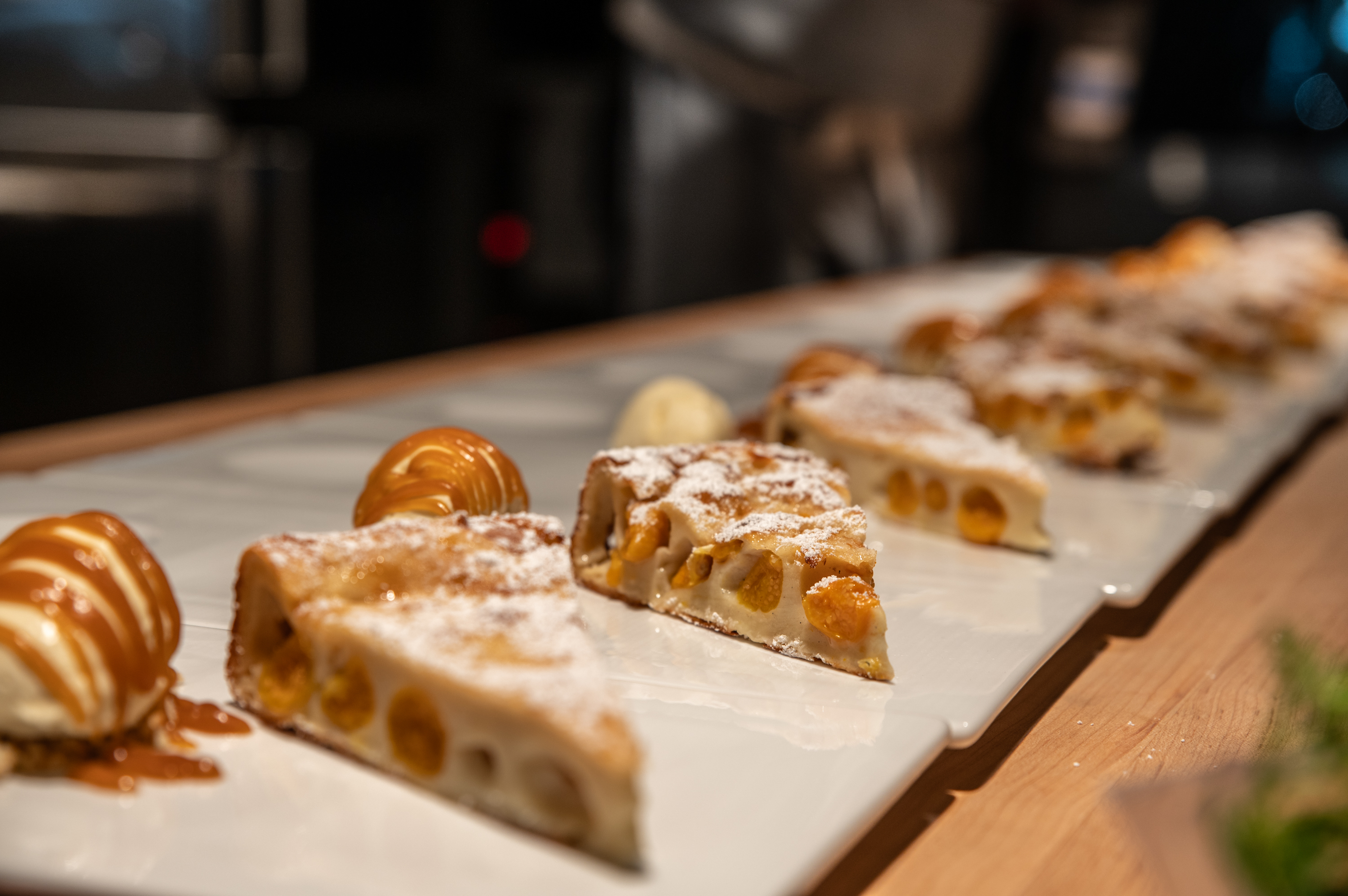 a slice of pizza sitting on top of a cutting board with a cake