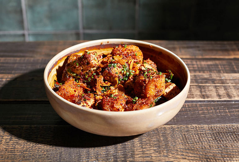 a bowl of food sitting on a table