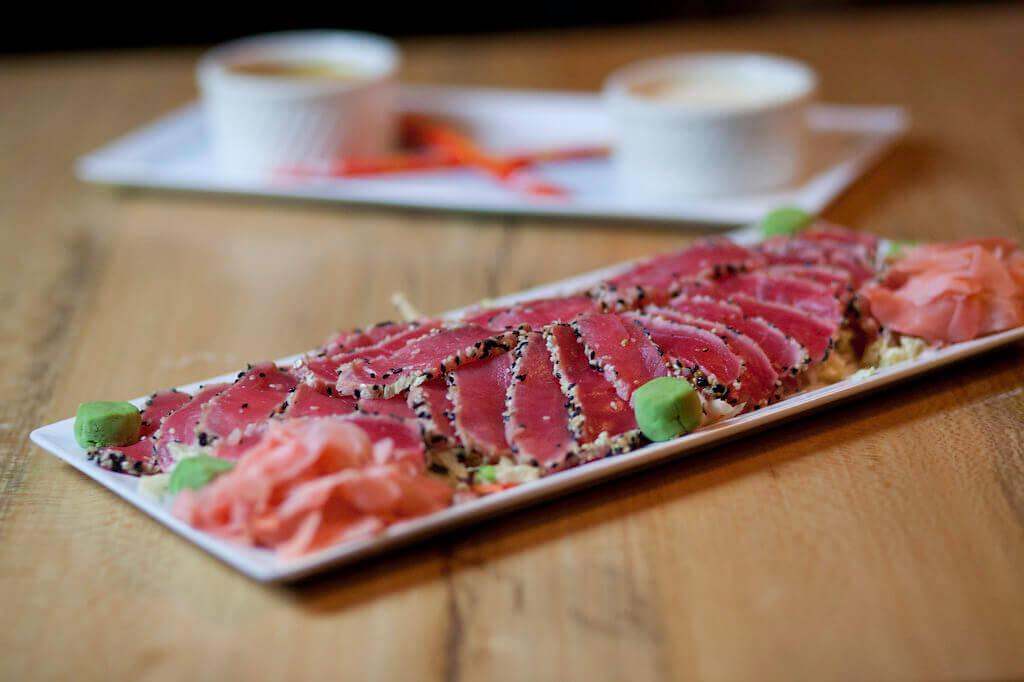 a slice of pizza sitting on top of a wooden table