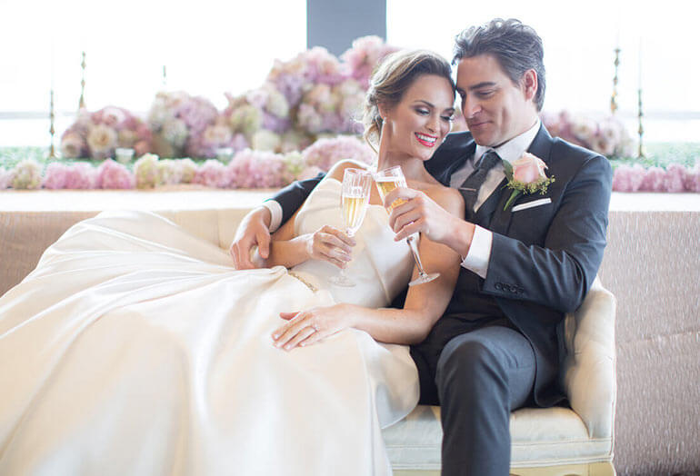 a man and a woman sitting on a bed