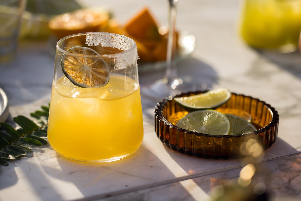 a glass of orange juice on a table