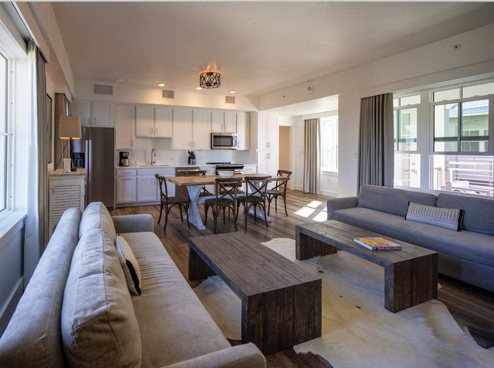 a living room filled with furniture and a large window