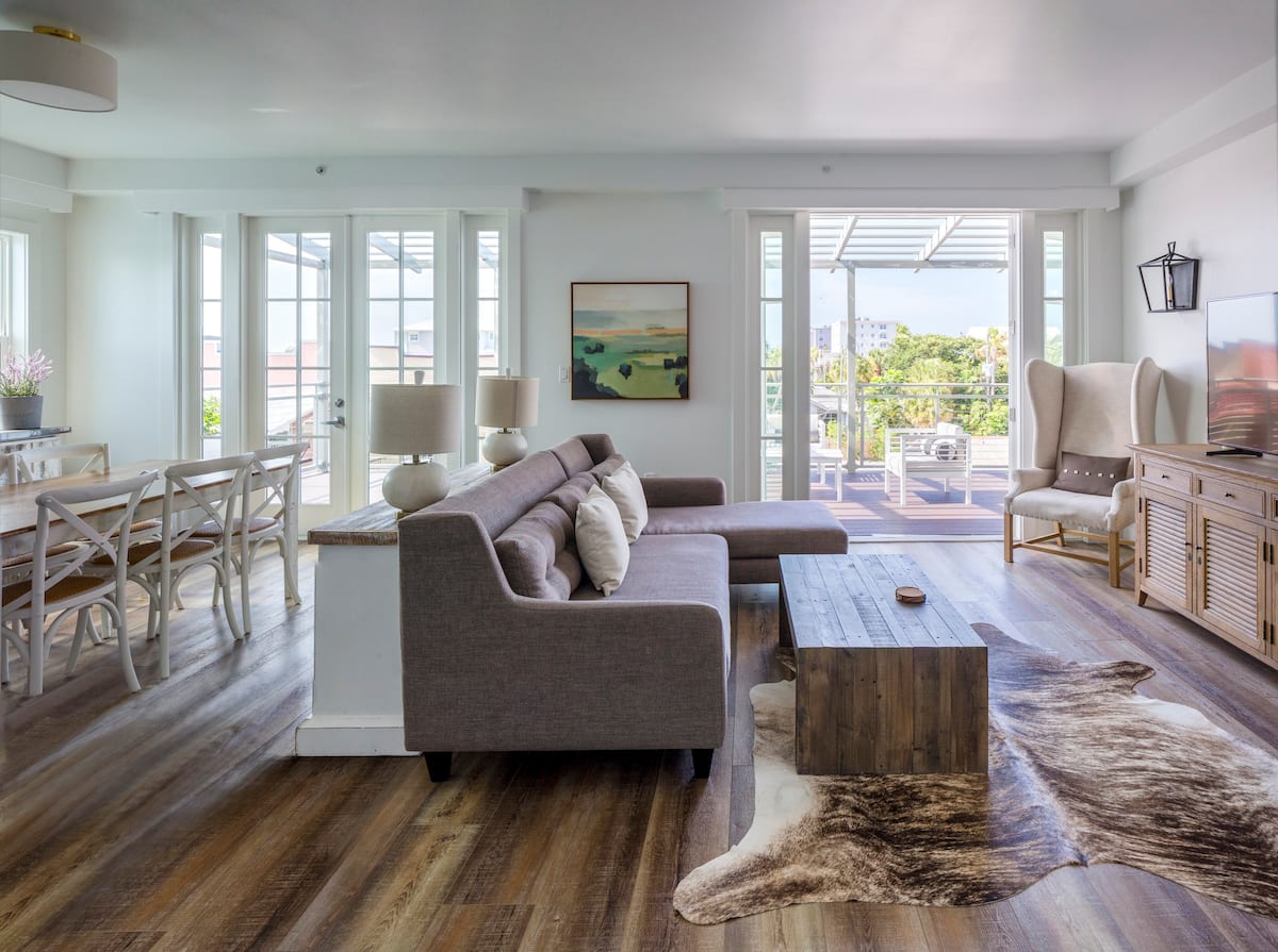 a living room filled with furniture and a large window