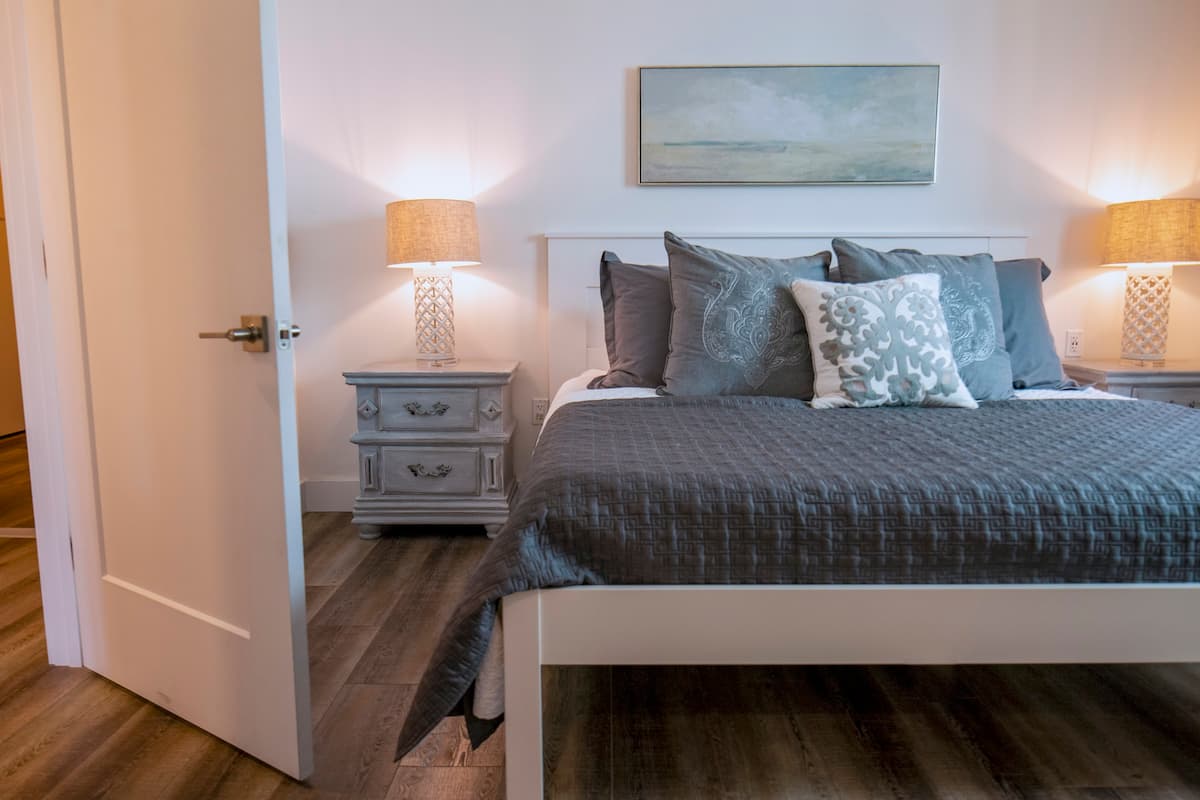 a bedroom with a bed and desk in a room