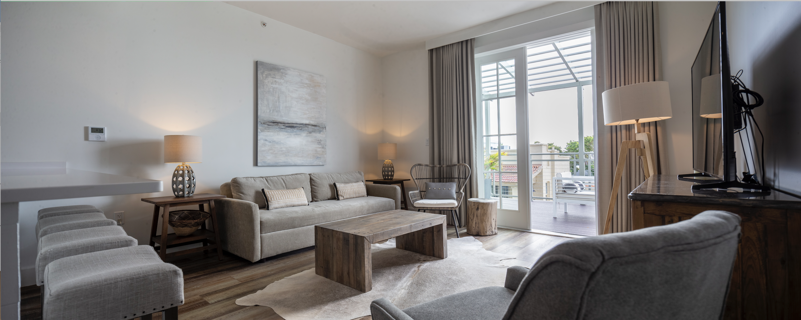 a living room filled with furniture and a large window