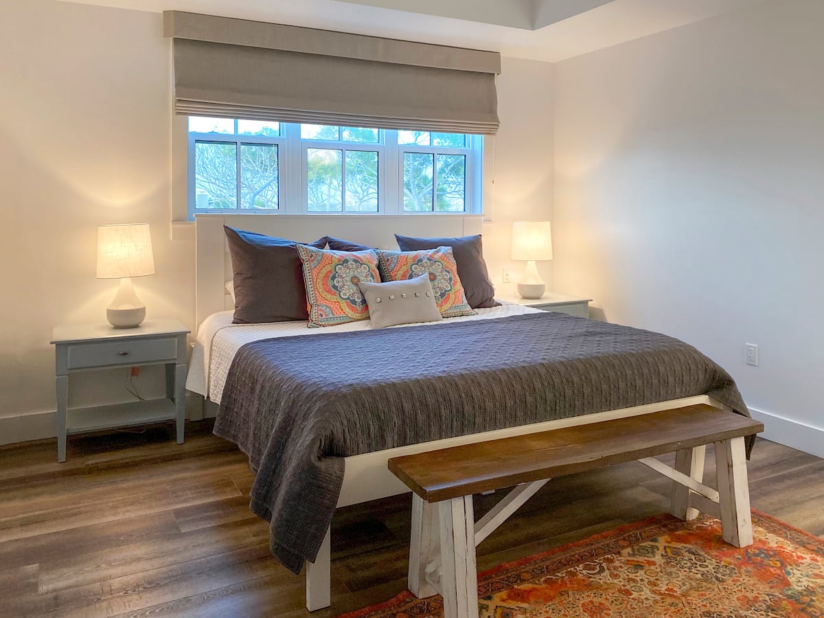 a bedroom with a bed and a chair in a room