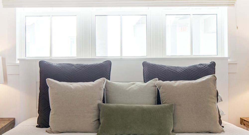 a living room filled with furniture and a large window