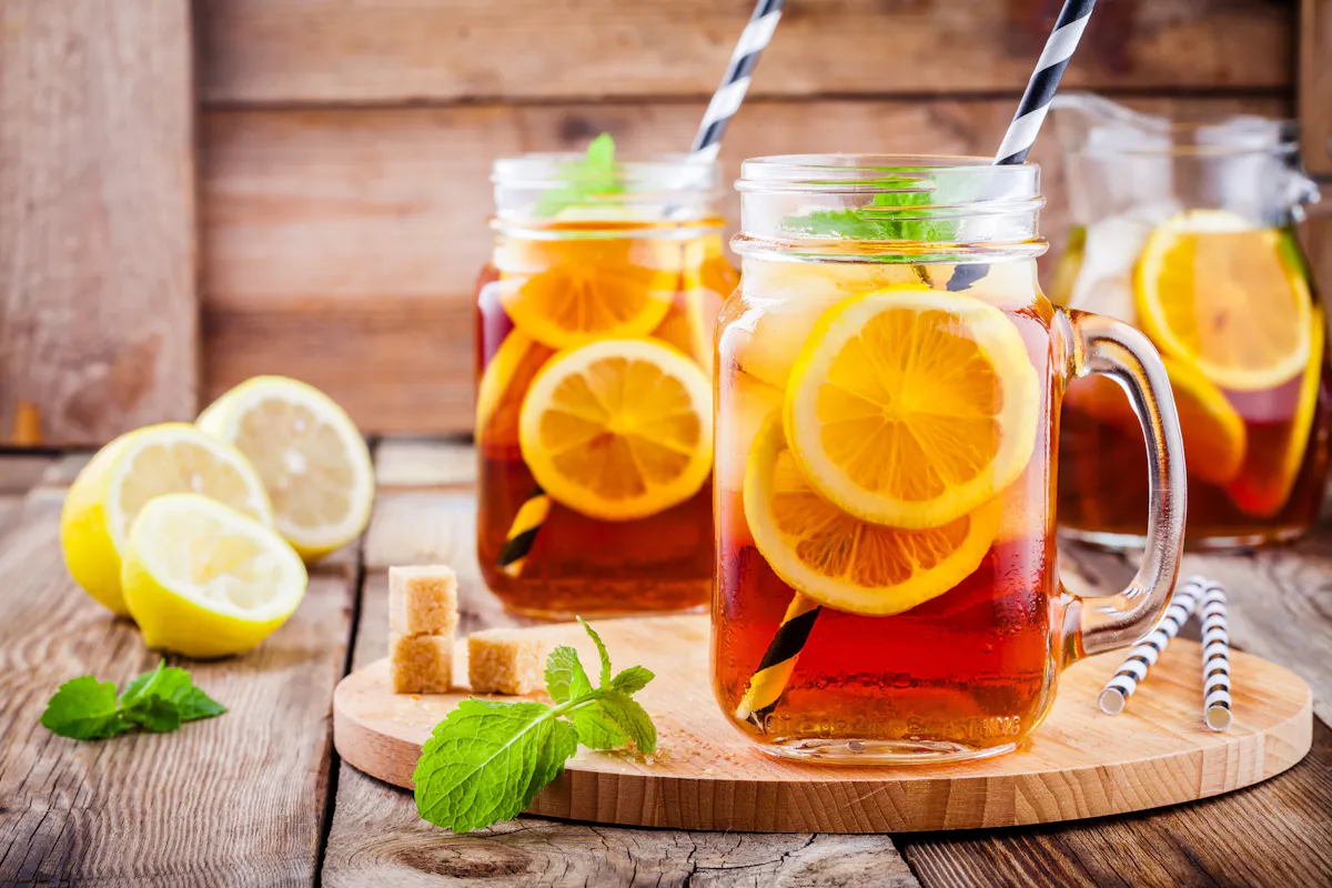 a glass of orange juice on a wooden table
