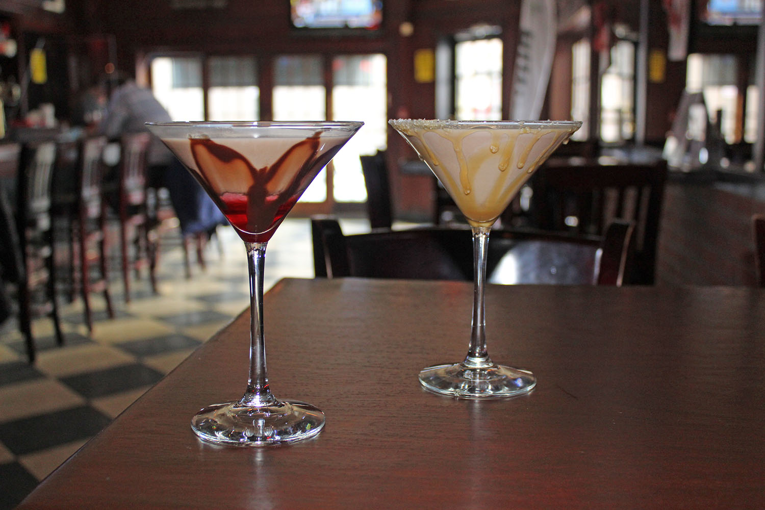 a glass of wine sitting on top of a wooden table