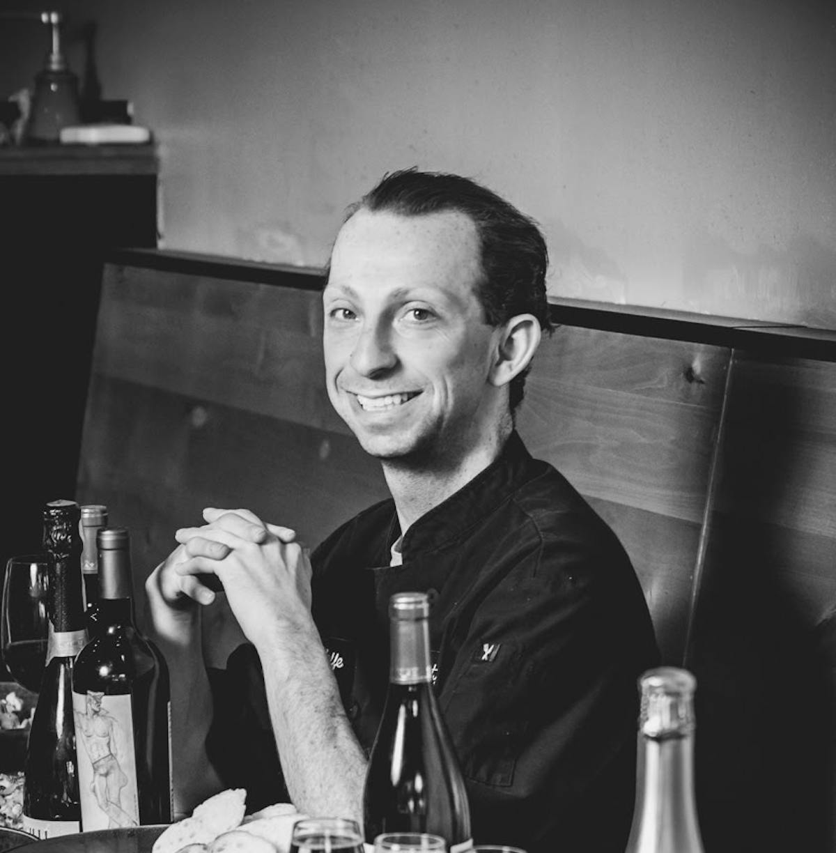 a man drinking a glass of wine