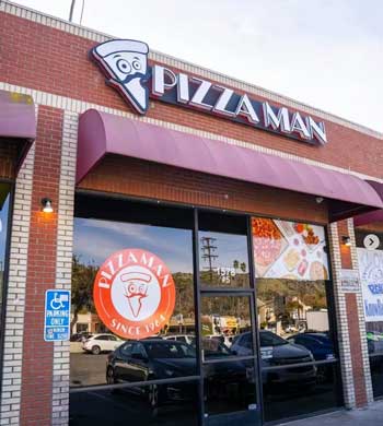 a pizzaman restaurant storefront with a sign