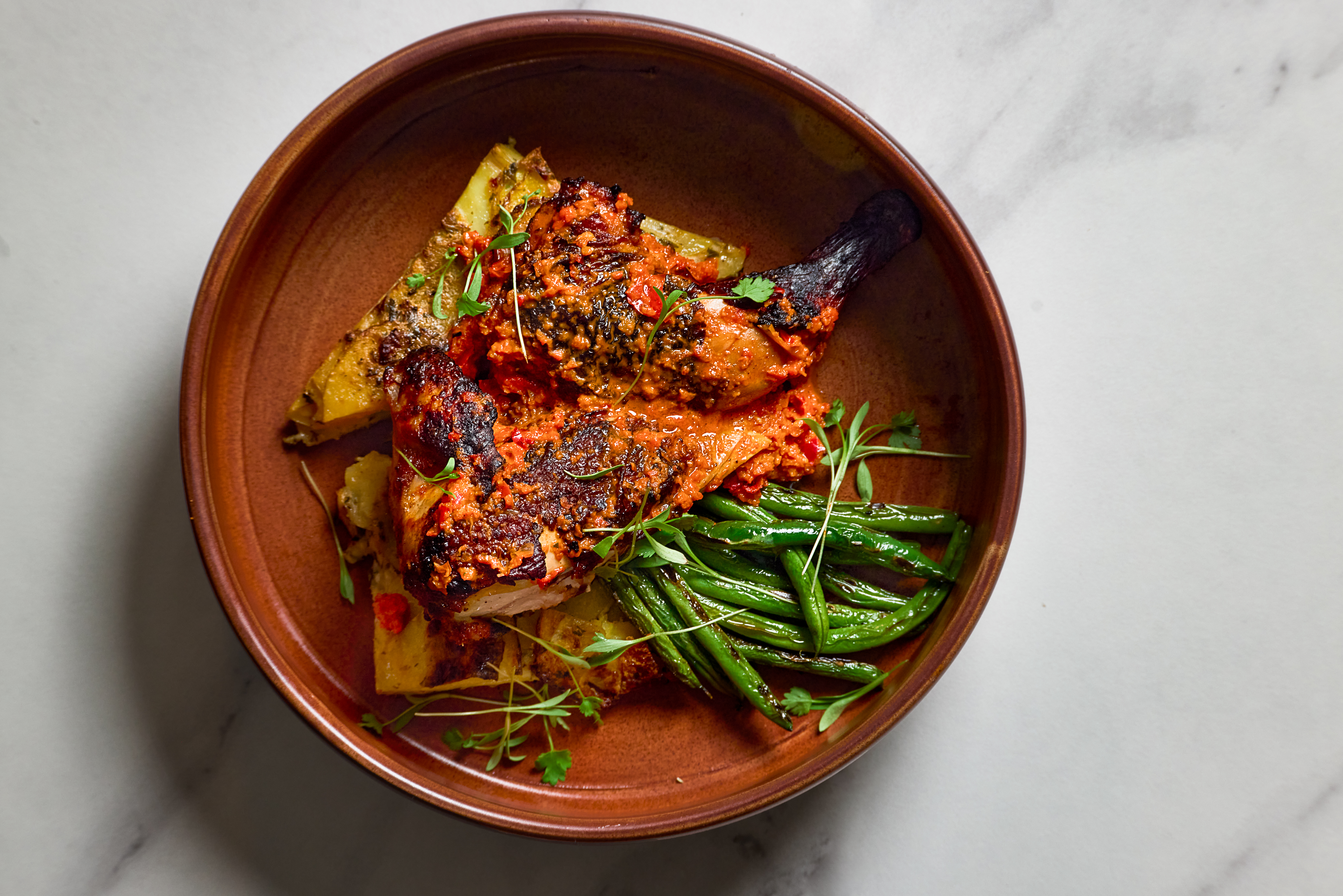 Bar Esper a bowl of food with meat and vegetables
