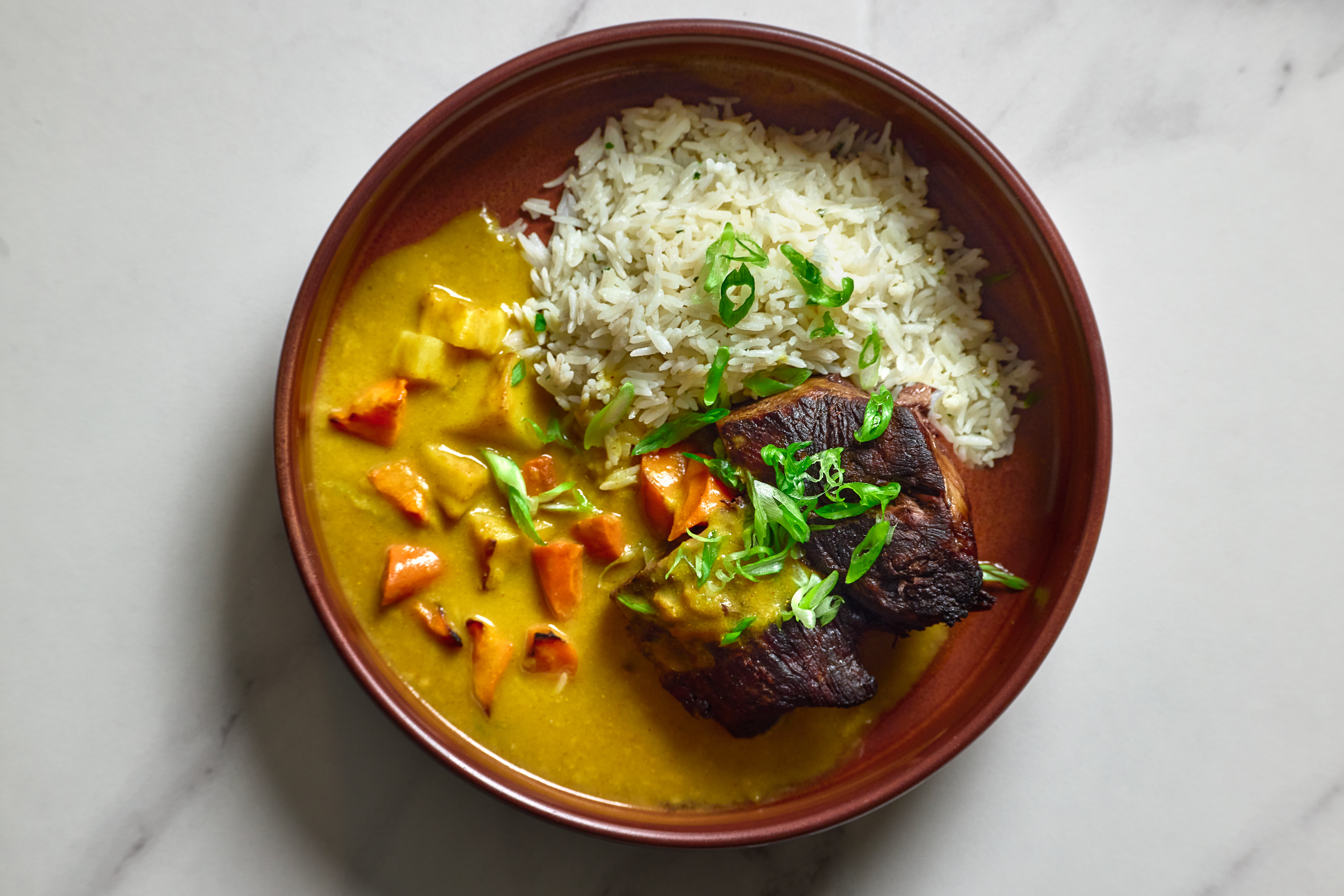 Bar Esper a bowl of food with rice and meat