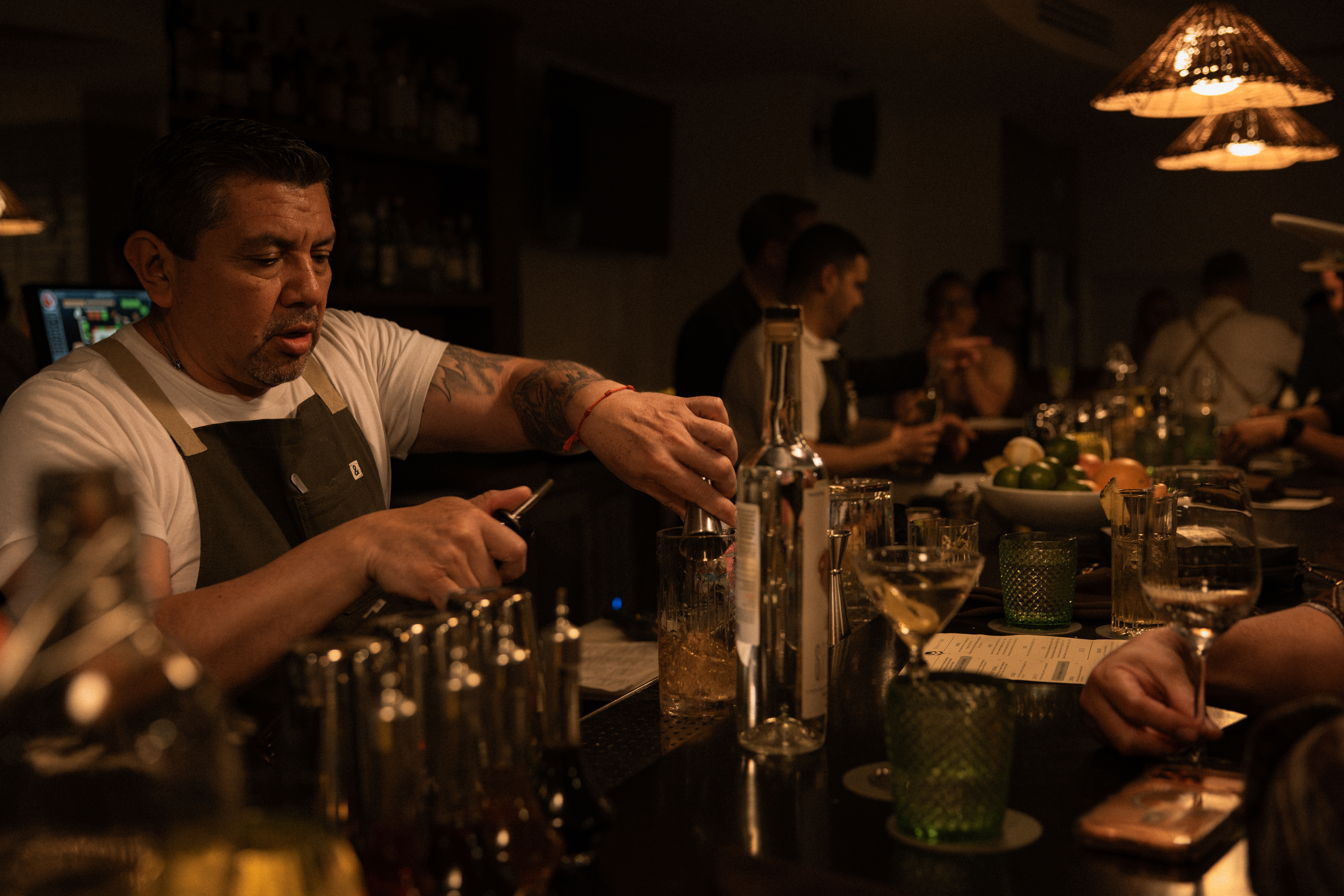 a man pouring a drink into a glass