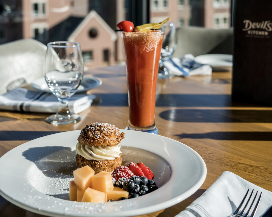 a plate of food and a glass of orange juice
