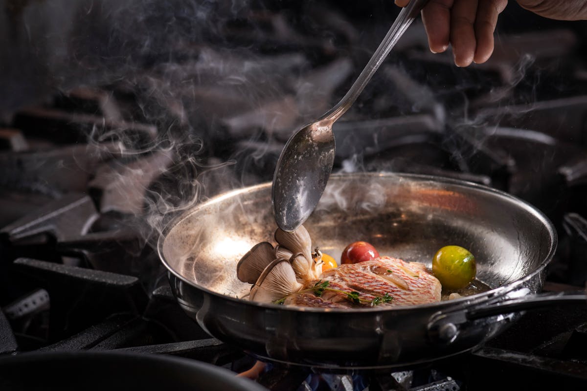 a person cooking food in a bowl