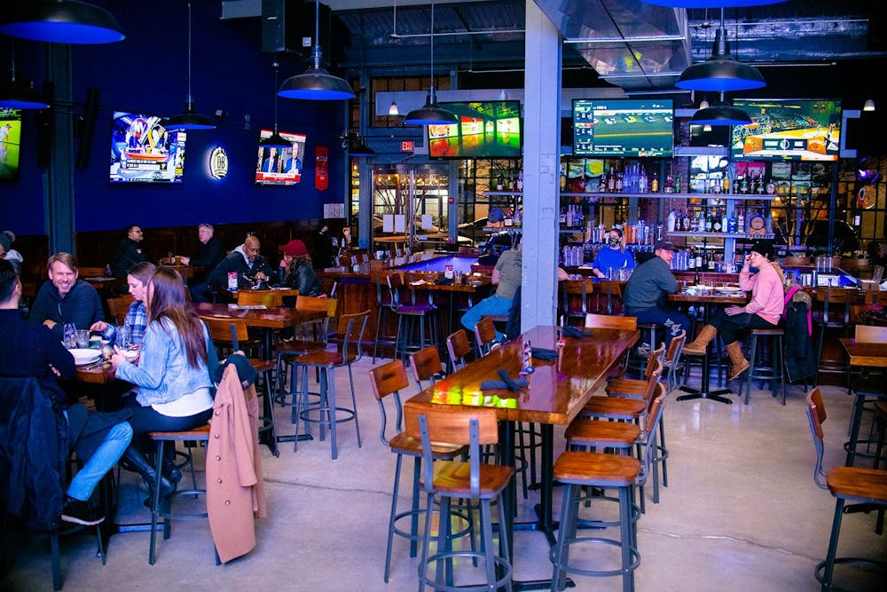 a group of people sitting at a table in a restaurant