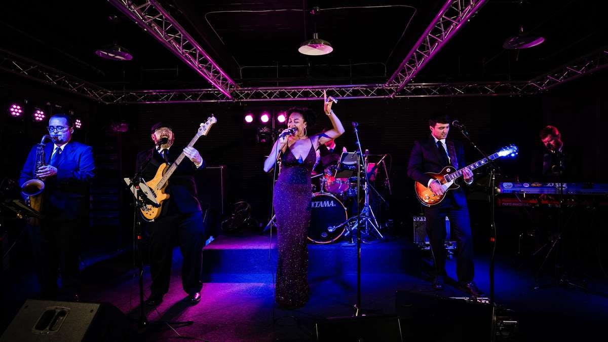 a group of people playing instruments on a stage