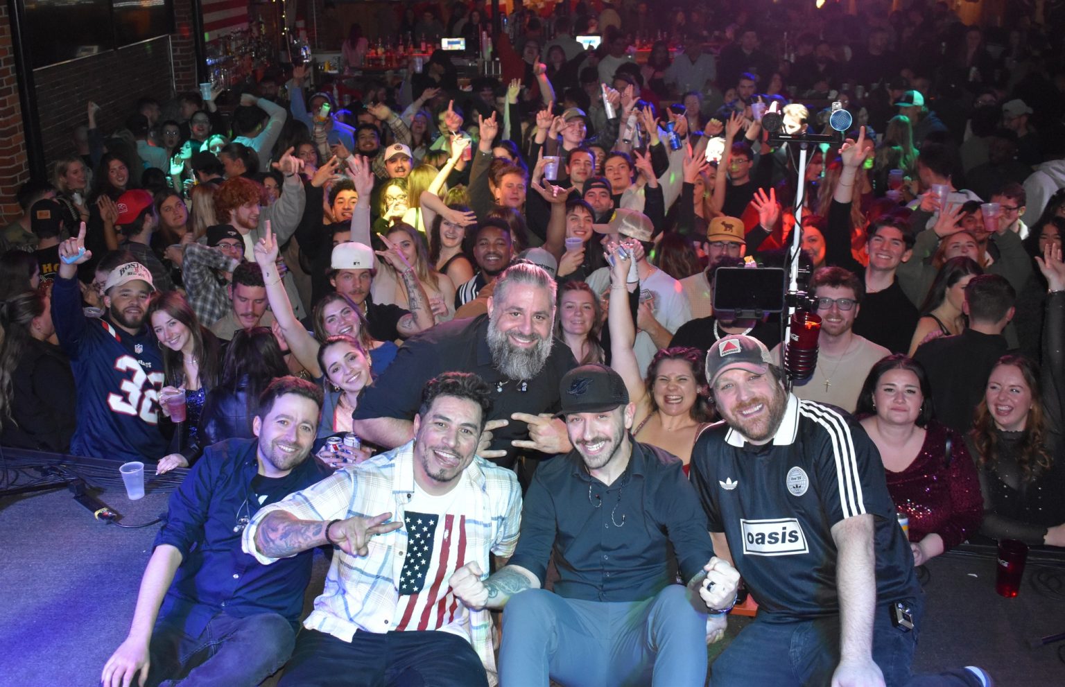 a group of people posing for a photo in front of a crowd
