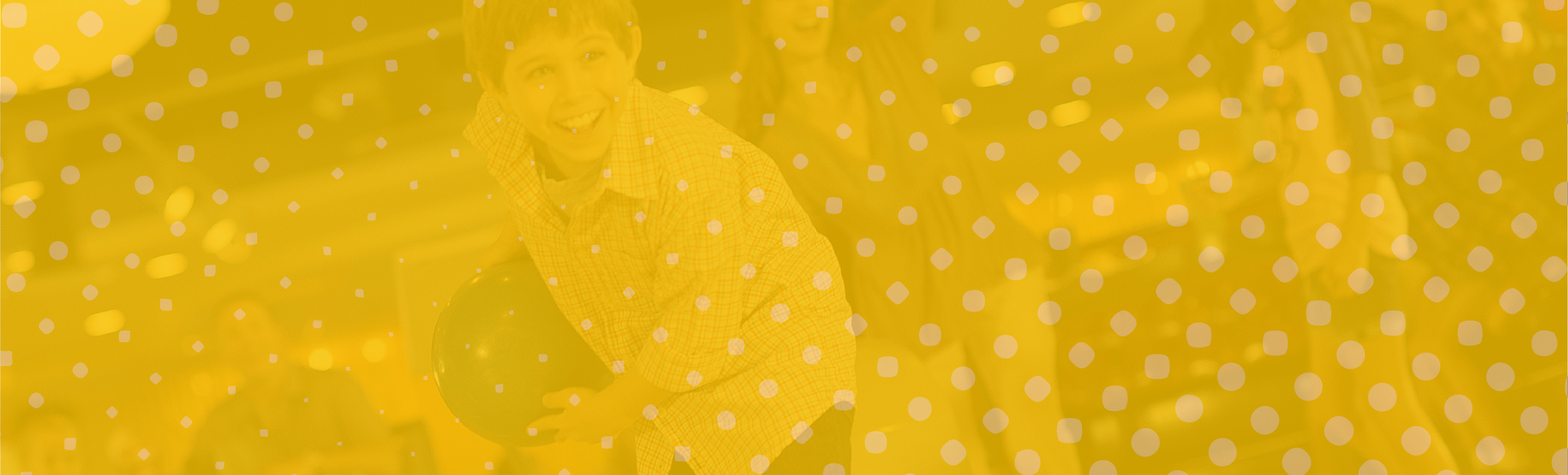 a boy smiling and sitting on a chair