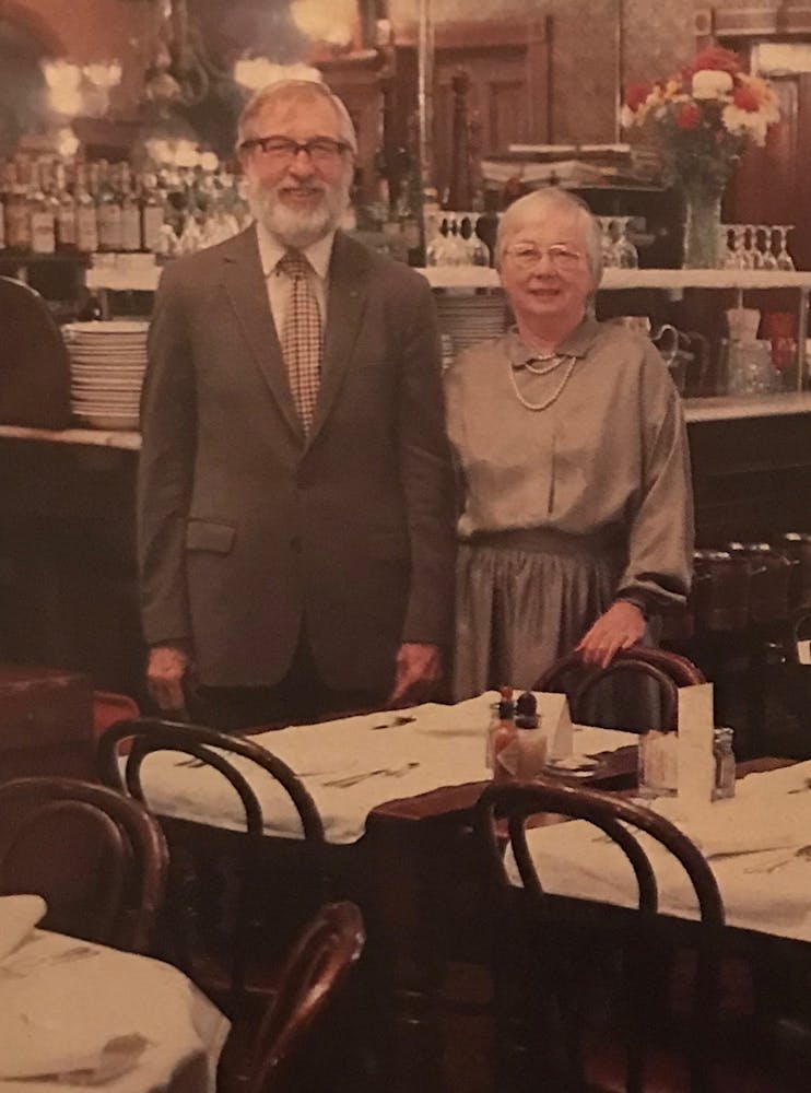 a man and a woman standing in front of a store