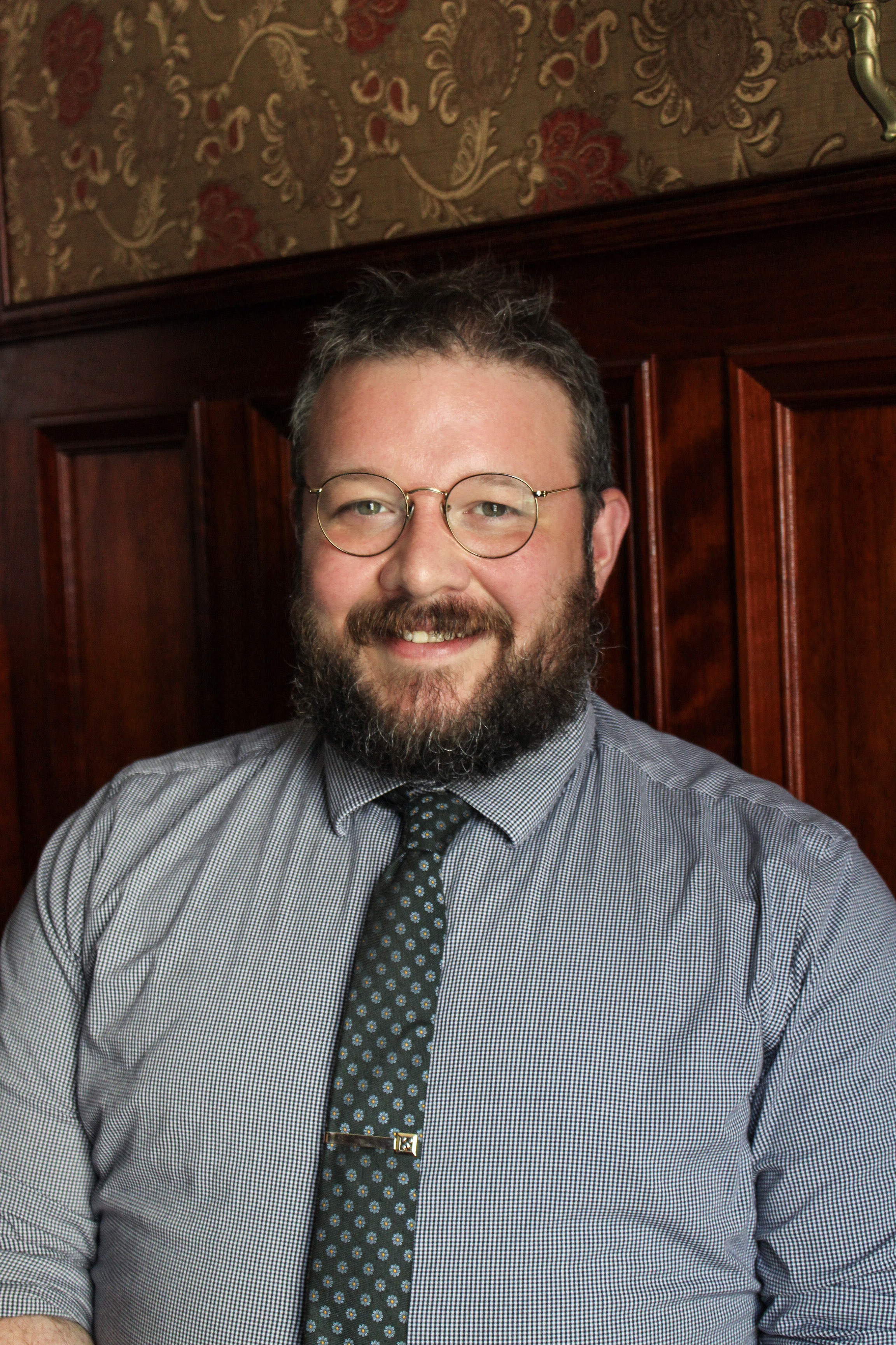 a man wearing glasses and a tie