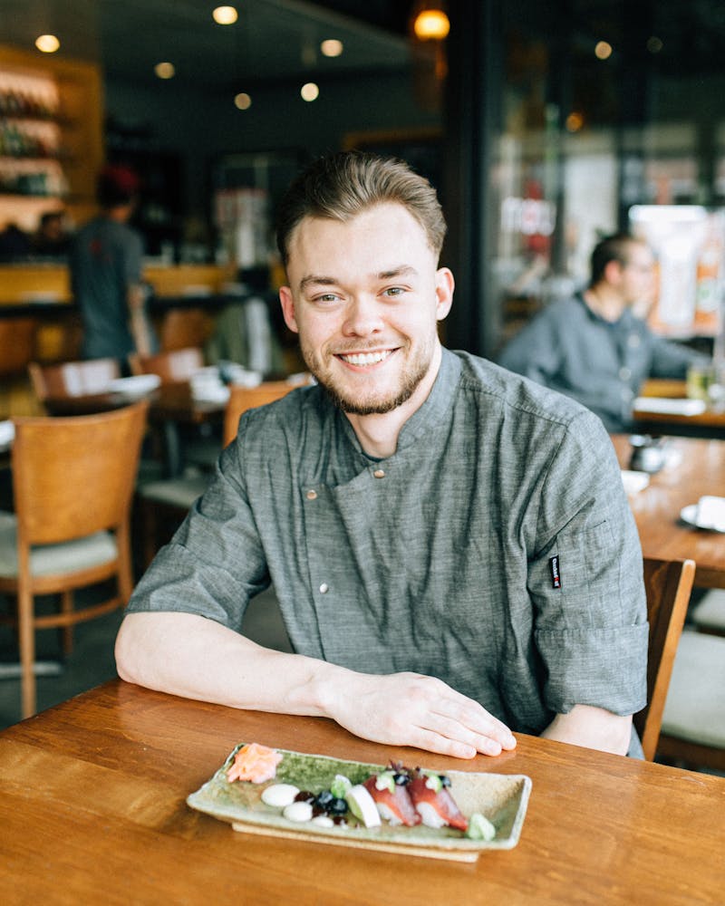 a person sitting at a table in a restaurant