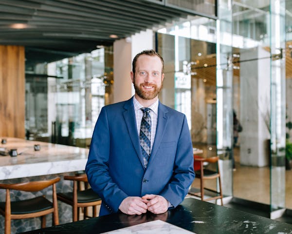 a man sitting at a table in front of a building