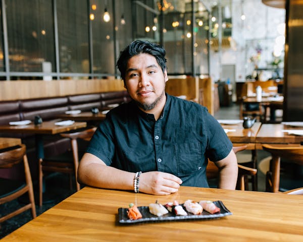 a man sitting on a wooden table