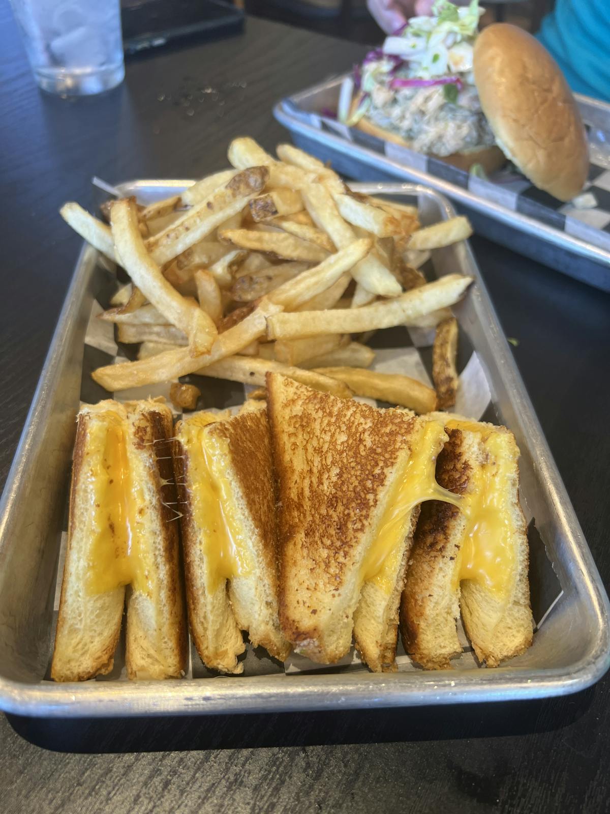a tray of food with a sandwich and fries on a table