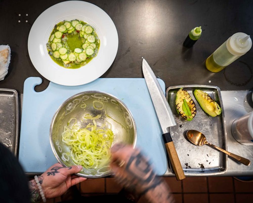 a person holding a bunch of food on a plate