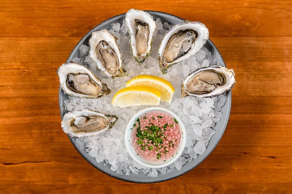 a bowl of food sitting on top of a wooden table