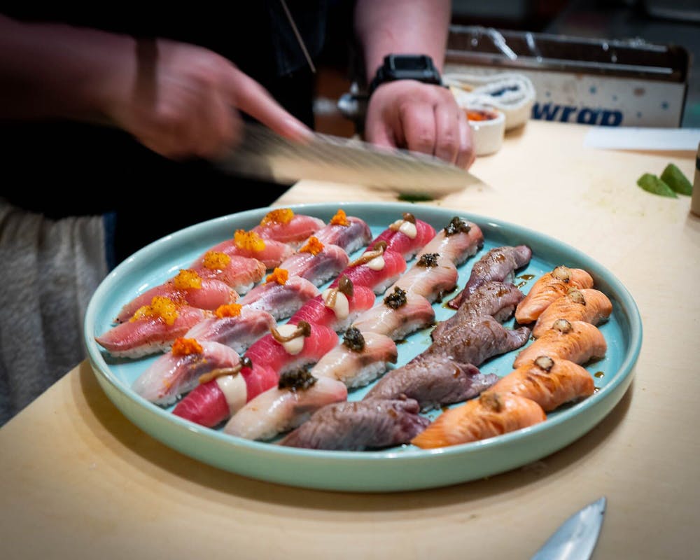 a woman sitting at a table with a plate of food