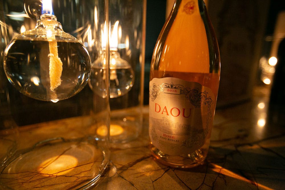 Daou-Rosé-at-Lionfish-San-Diego a close up of a bottle and a glass of wine