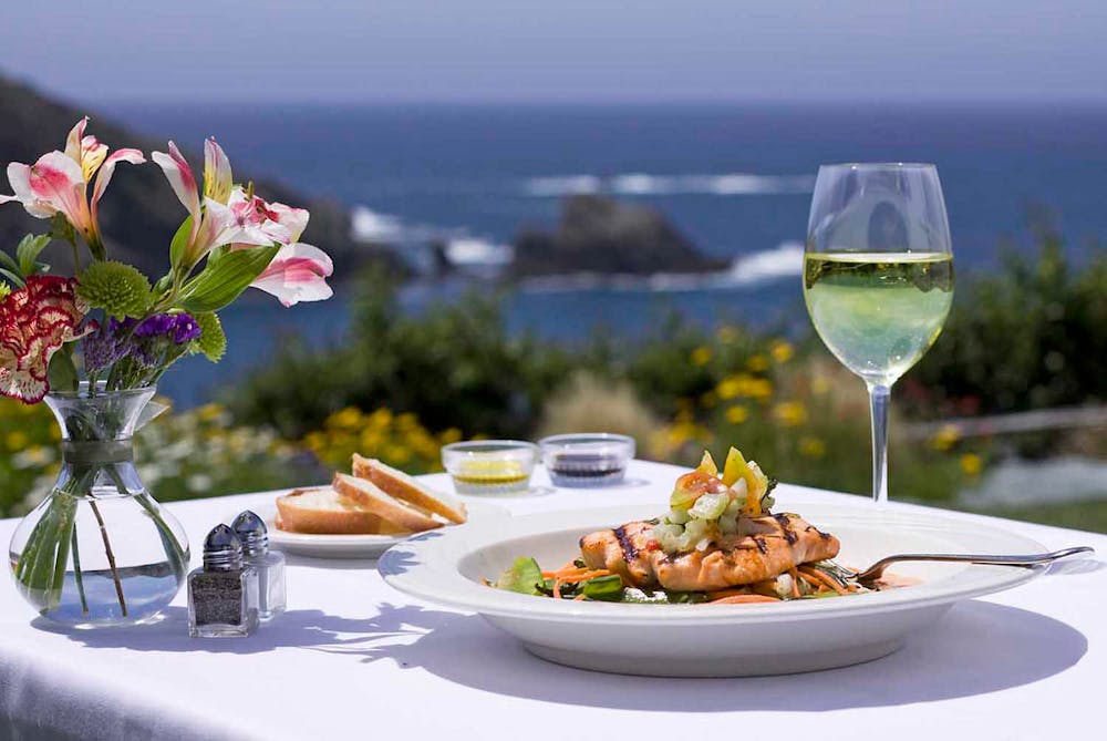 a plate of food and a glass of wine