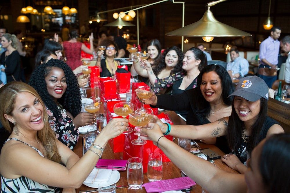 a group of people sitting at a table with wine glasses