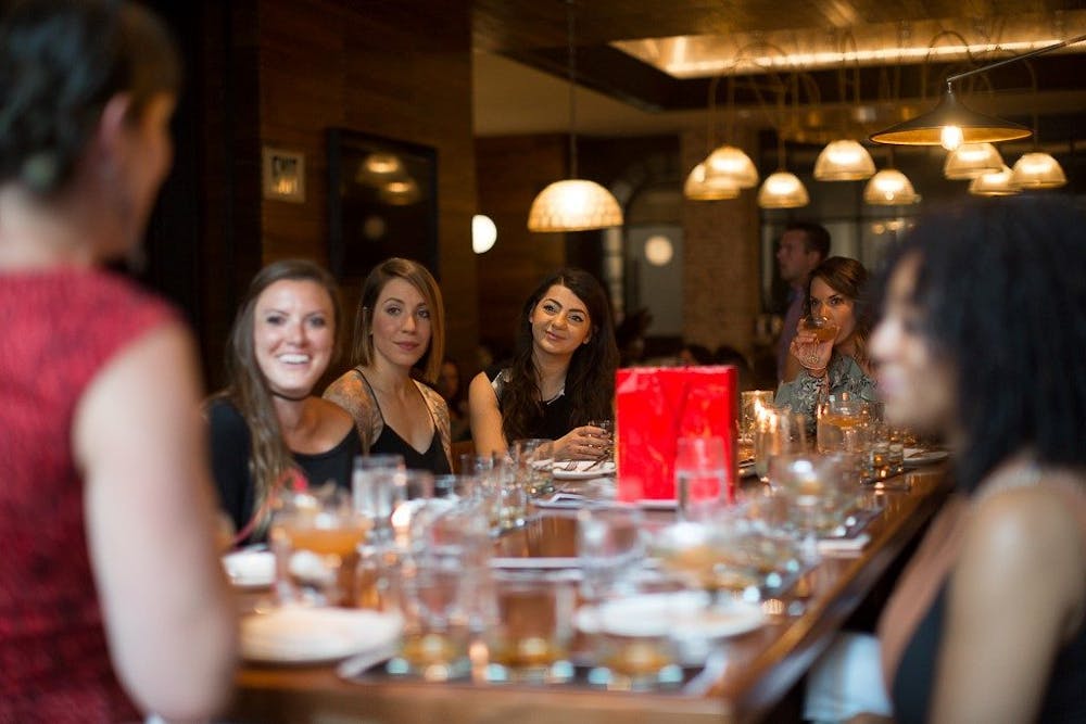 a group of people sitting at a table in a restaurant