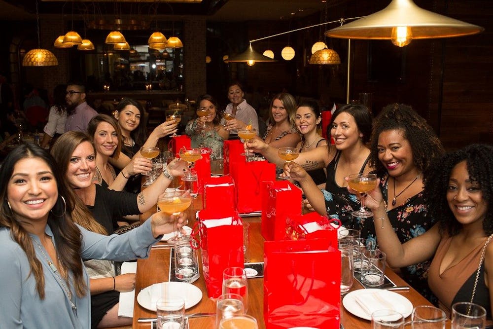 a group of people sitting at a table with wine glasses