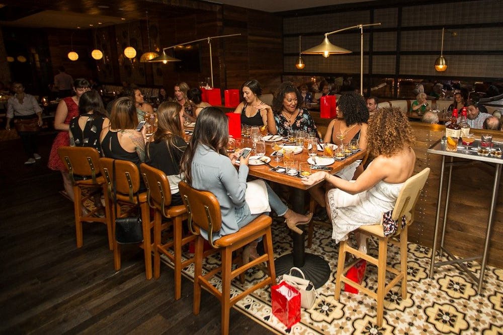 a group of people sitting at a table in a restaurant