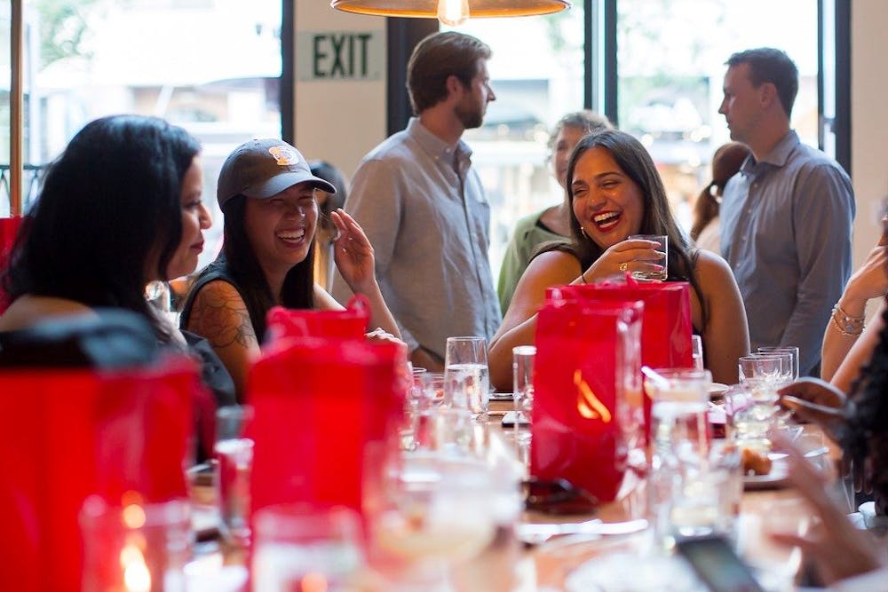 a group of people sitting at a table with wine glasses