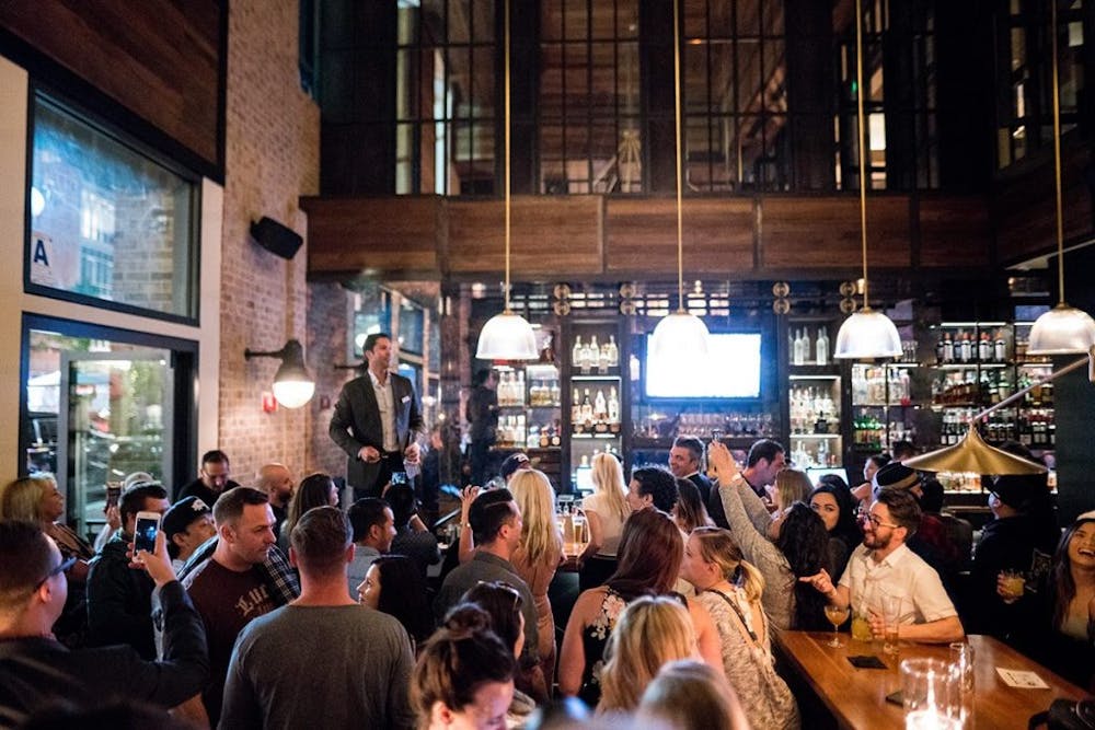 a group of people sitting at a table in front of a crowd