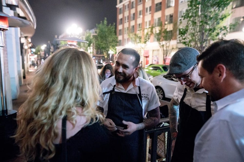 a group of people looking at a phone