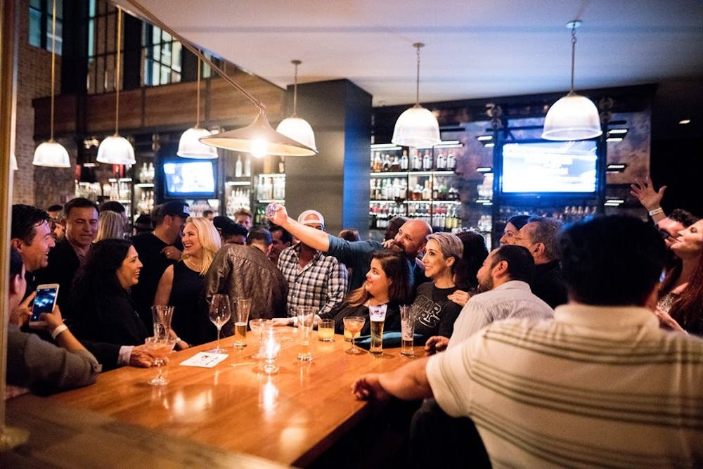 a group of people sitting at a table with wine glasses