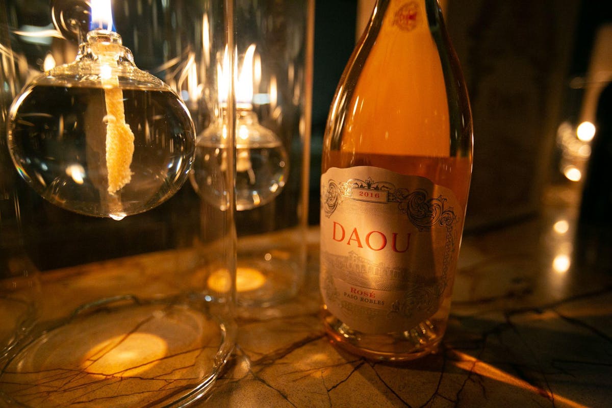 a bottle of wine and a glass of beer on a table