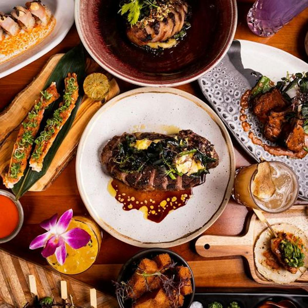 a plate full of food sitting on top of a wooden table