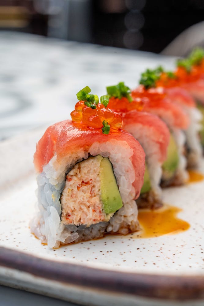 a close up of a plate of food with a slice of sushi