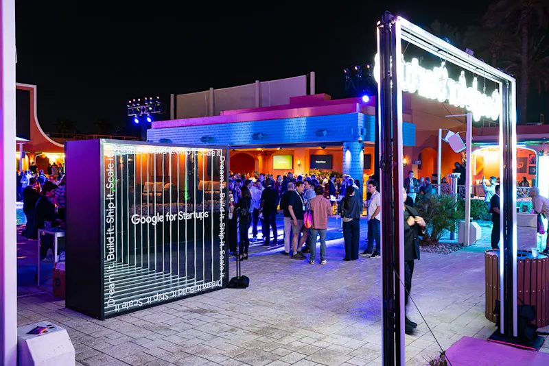 Guests gathered under the LED colonnade at night