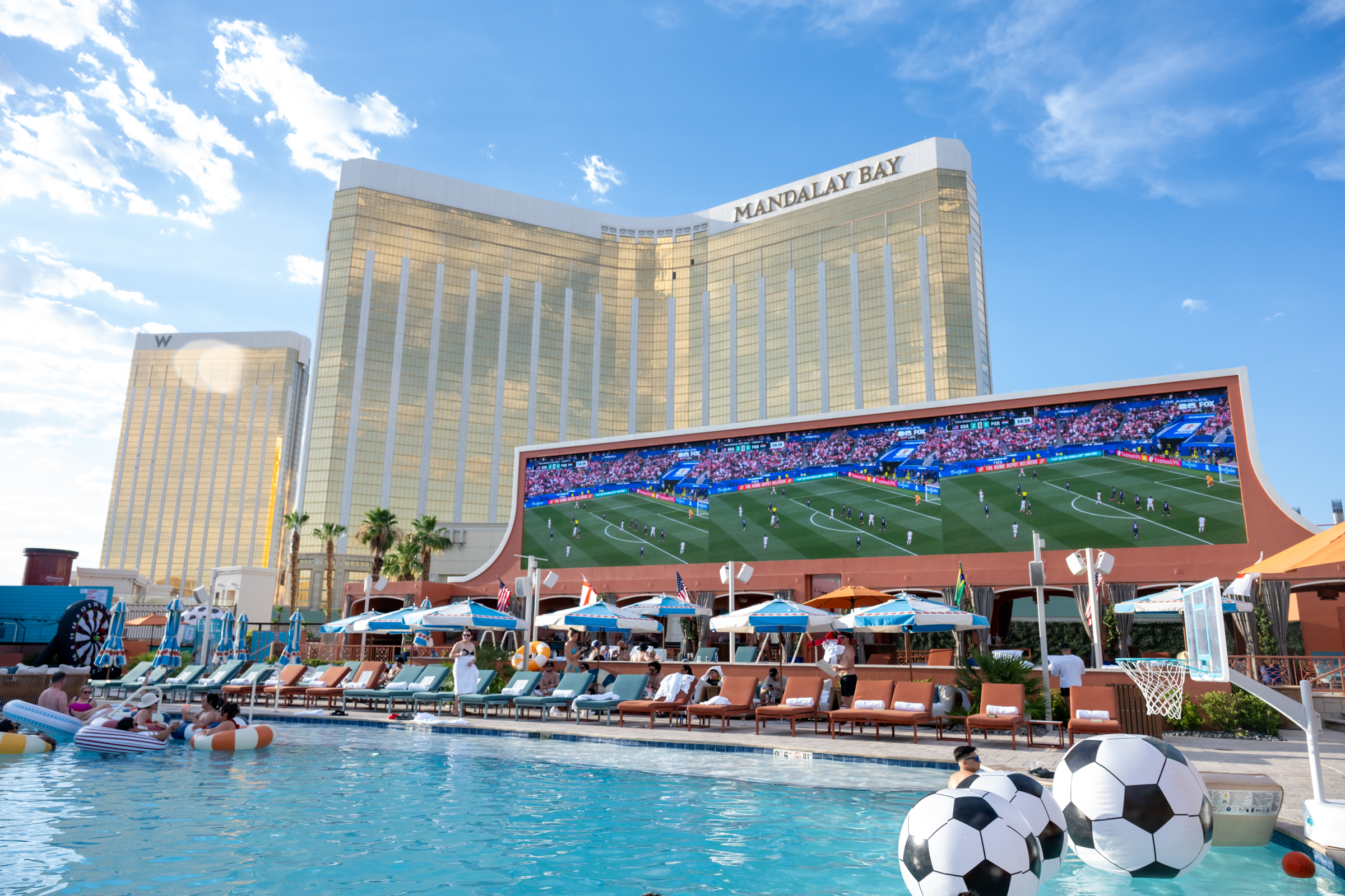 a pool with a large building and a football field