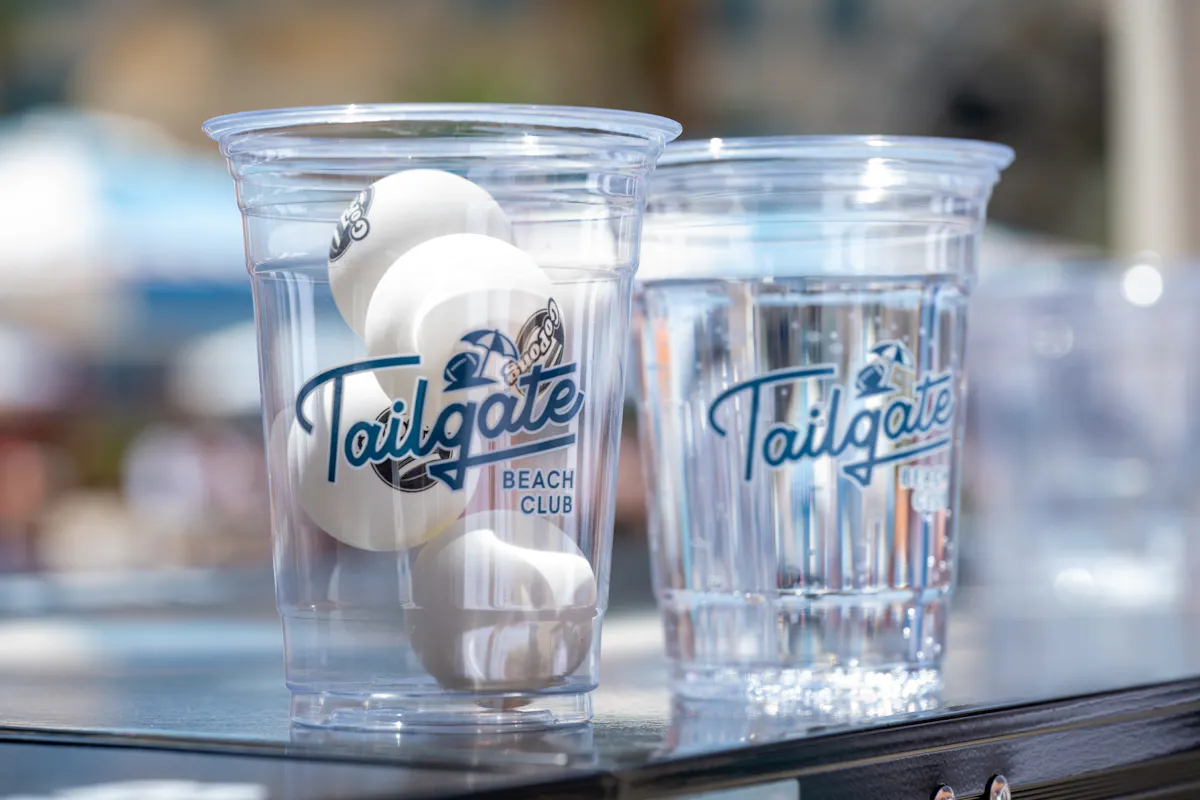Branded cups and pong balls close-up at Tailgate Beach Club